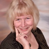 Connie Minnett Blond woman with a smile in business attire